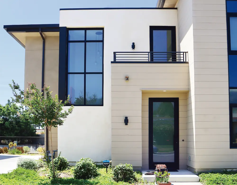 The modern house features aluminum windows and doors