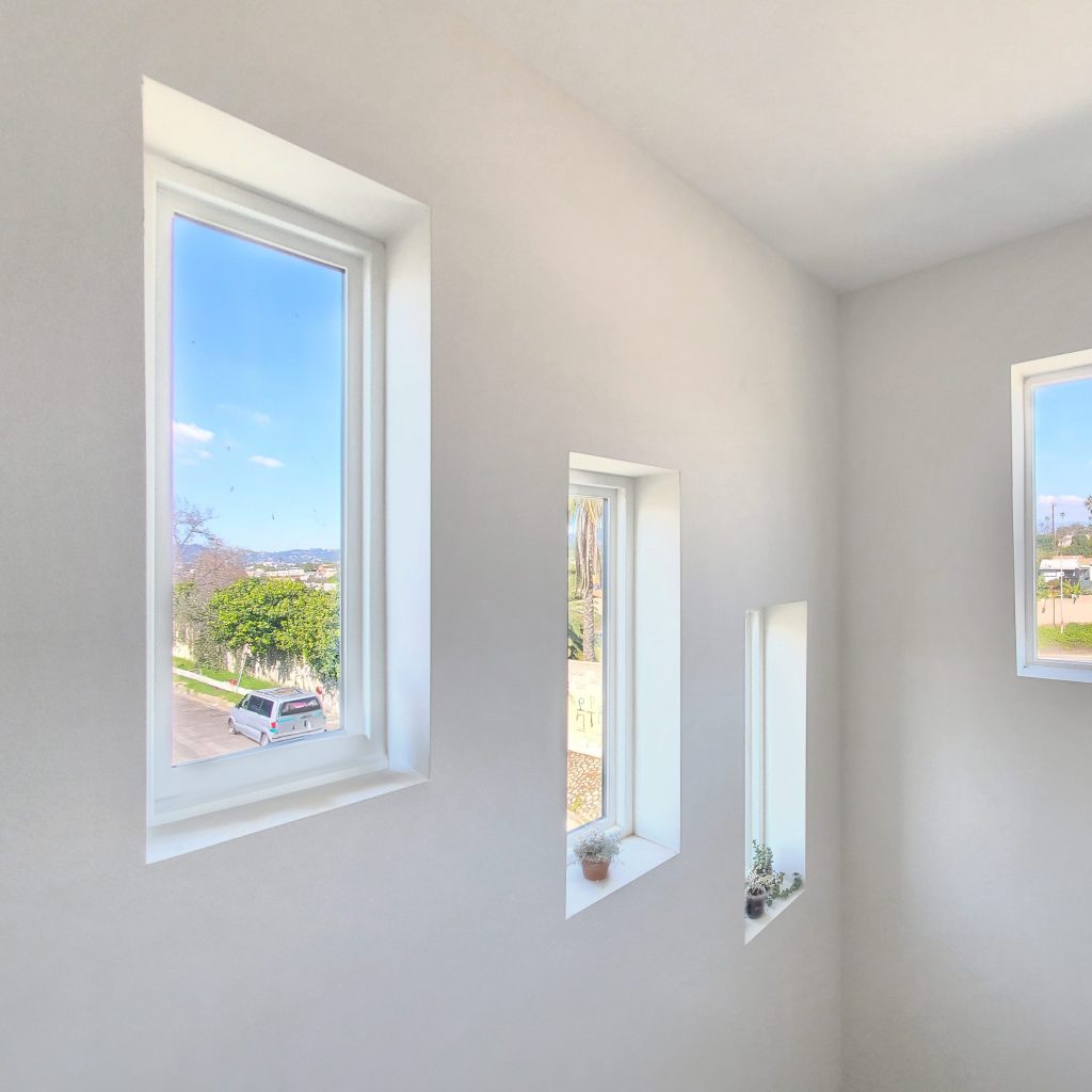 three GS Series picture windows showing outdoor scenes.